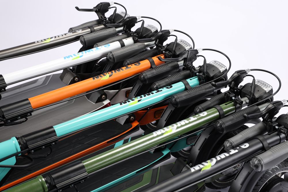 Stack of folded E Twow GT SL with different colored frames on a white background