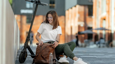 Best electric scooter for adults nz- Young female beside an electric scooter