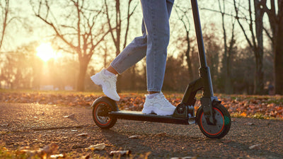 Where can you ride an e-scooter concept image: Person riding on e-scooter in the park