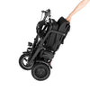 Black folding electric wheelchair being held by a person on a white background