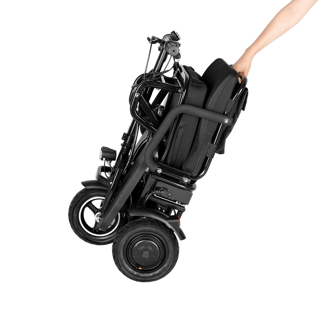 Black folding electric wheelchair being held by a person on a white background