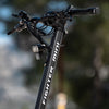 Close-up of a Teverun fighter Mini  e scooter handlebar with 'Run Fighter Mini' branding against a blurred natural background.
