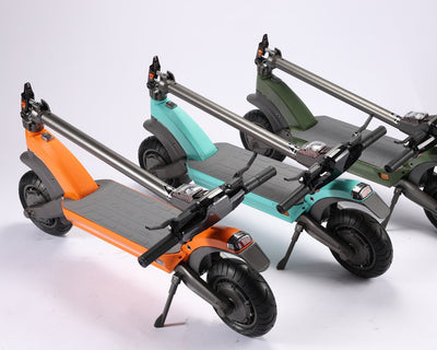 Three electric scooters in different colors on a white background