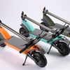 Three electric scooters in different colors on a white background