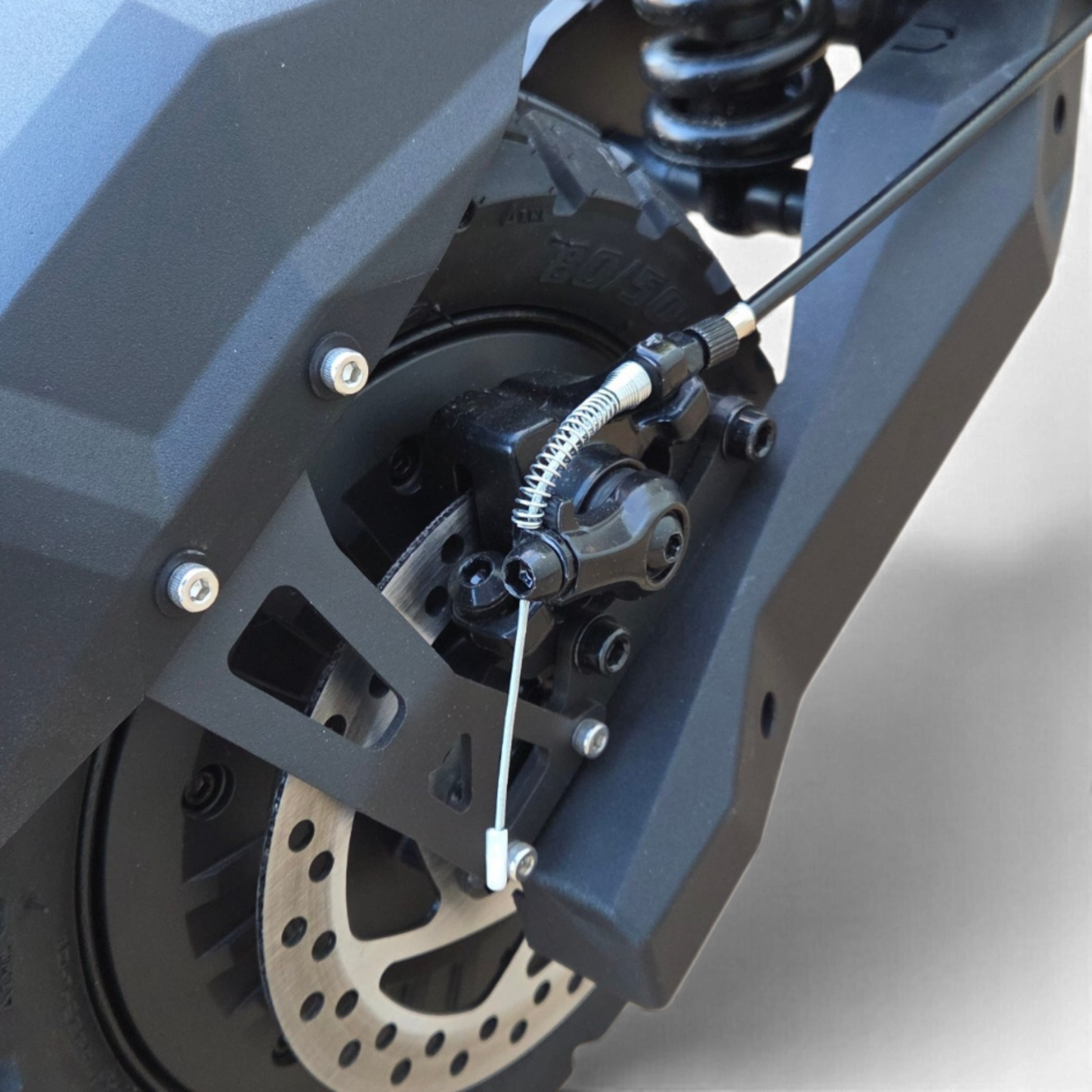 Electric Scooter Shop Punk Roamer electric scooter showing the black disc brake system and coil suspension detail.