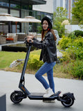 Girl in jeans posing with the Punk Rider Pro, Dual motor, waterproof electric scooter from Electric Scooter Shop in Auckland. Freed Electric Scooters.