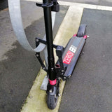 Etook folding lock locking a Zero 8 electric scooter to a bike rack in the city